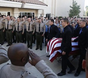 The casket carrying slain Los Angeles County Sheriff's Sgt. Steve Owen is carried into church on Thursday, Oct. 13, 2016 at Lancaster Baptist Church in Lancaster, Calif.
