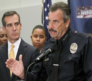 Los Angeles Police Chief Charlie Beck speaks as Los Angeles Mayor Eric Garcetti listens at left at a news conference to discuss mid year crime statistics in Los Angeles Wednesday, July 8, 2015.
