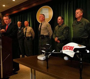 Los Angeles Sheriff Jim McDonnell, left, holds a news conference at the Hall of Justice in downtown Los Angeles to announce the recent approval from Federal Aviation Administration authorities for the use of an unmanned aircraft system, at bottom right, on Jan. 12.