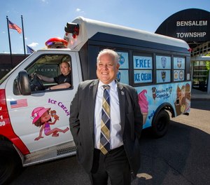 Bensalem Township Police Director Fred Harran (front) and Police Sgt. Greg Winokur (behind the wheel) pose with The Bensalem PD's new ice cream truck - aka the Copsicle Cruiser.