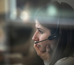 Kathryn Haeffner, an emergency service counselor, provides guidance during a follow-up call at the crisis call center in the DuPage County Health Department on Jan. 6, 2020.