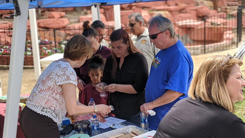 Residents attend a presentation of a crime-free multi-housing certificate after the "Phoenix Zone" project had significantly reduced crime.
