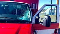 Flying piece of wood smashes windshield of ambulance in transit
