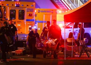 Multiple victims were being transported to hospitals after a shooting late Sunday at a music festival on the Las Vegas Strip. (Chase Stevens/Las Vegas Review-Journal via AP)