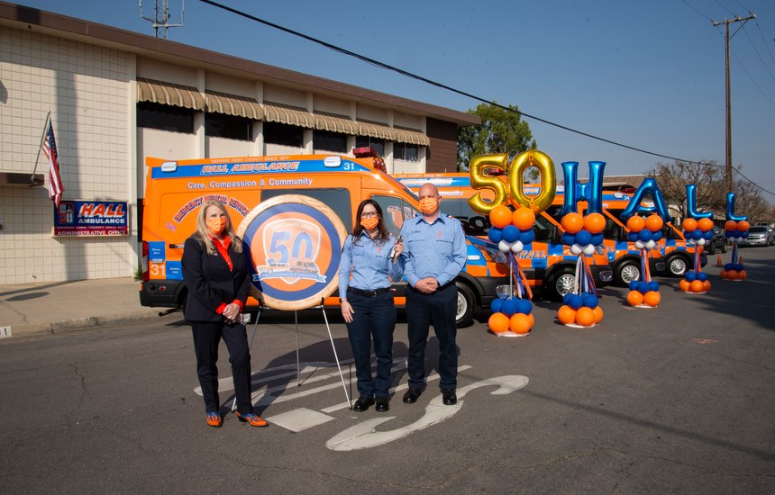 Hall Ambulance President and CEO Lavonne C. Hall (left) presents the keys to a new 50th-anniversary ambulance to Paramedic Karissa Thompson (center) and EMT Elliott Smith.