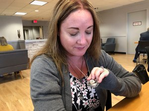 Lori Alhadeff shows a pendant bearing a photo of her 14-year-old daughter Alyssa, among the 17 people killed during the 2018 massacre at Marjory Stoneman Douglas. Image: AP Photo/Bobby Caina Calvan