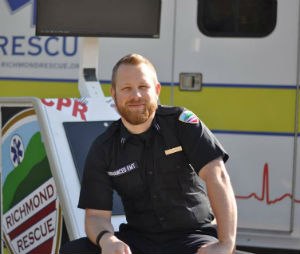 Luke Jackson, AEMT, with the hands-only CPR kiosk he designed and built for Richmond Rescue