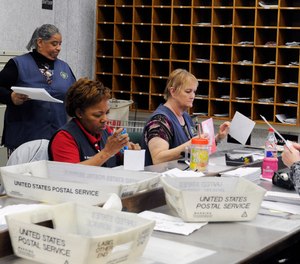 In this Feb. 5, 2016, photo, mail clerks at the Wynne Unit of the Texas prison system inspect boxes of letters for inmates in Huntsville, Texas.