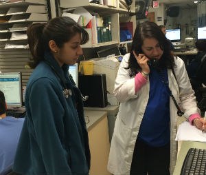 Vaishali Shah, M.D., Pediatric Emergency Medicine Attending and Shamyla Farrukh, M.D., Pediatric Emergency Medicine Fellow, pictured left to right, provide consultation to a paramedic unit with a critically injured child.