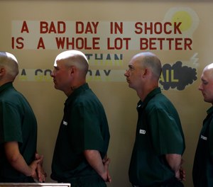 Inmates line up for lunch at the Moriah Shock Incarceration Correctional Facility Wednesday, Aug. 22, 2012, in Mineville, N.Y. The facility is one of six slated for closure in March 2022.