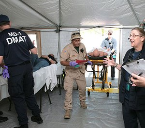 DMAT members from teams across the U.S. work together in response to a mass casualty exercise. DMATs are part of the National Disaster Medical System (NDMS) that boosts the nation’s medical response in support of state and local authorities during a disaster.