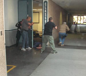 Students practice tracking the active shooter by following the trail of destruction in this NTC exercise.