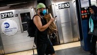 Wary New York subway riders carry on amid virus concerns