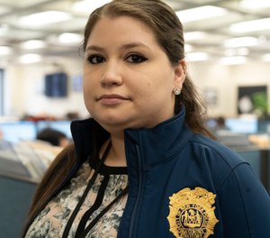 Rebecca Shutt, who works in the New York Police Department's Office of Crime Control Strategies, poses for a photo in New York (AP Photo/Mark Lennihan)