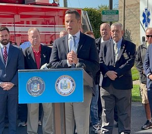 Sen. Elijah Reichlin-Melnick (speaking) and Assemblyman Ken Zebrowski touted the property tax exemption bill this fall at a press conference at the Nanuet Fire Engine Company.