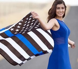 Natalie Corona waving the thin blue line flag (Photo/ Natalie Corona via Facebook)