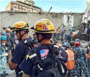 In this May 12, photo provided by the U.S. Agency for International Development, Los Angeles County Fire Department urban search and rescue team memebrs work to recover survivors from a four-story building that collapsed in this week’s earthquake in Singati, a mountain village in Nepal. (Kashish Das/USAID/via AP)
