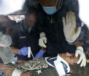 A U.S. doctor attends to Pemba Tamang inside an ambulance after being rescued by Nepalese policemen and U.S. rescue workers from a building that collapsed five days ago in Kathmandu, Nepal, Thursday, April 30, 2015. Crowds cheered Thursday as Tamang was pulled, dazed and dusty, from the wreckage of a seven-story Kathmandu building that collapsed around him five days ago when an enormous earthquake shook Nepal. (AP Photo / Manish Swarup)
