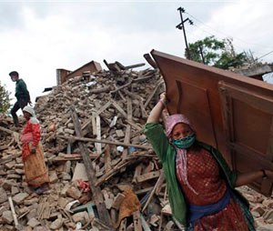 Nepalese earthquake-affected victims salvage belongings from their damaged homes in Lalitpur, on the outskirts of Kathmandu, Nepal, Thursday, April 30, 2015. In mere seconds, Saturday’s earthquake devastated a swathe of Nepal. Three of the seven World Heritage sites in the Kathmandu Valley have been severely damaged, including Durbar Square with pagodas and temples dating from the 15th to 18th centuries, according to UNESCO, the United Nations cultural agency. (AP Photo/Niranjan Shrestha)
