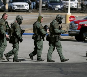 Emergency medical technicians carry a person on a stretcher into an ambulance outside the Quality Inn on Thursday, March 28, 2019, in Manchester, N.H. (AP Photo/Charles Krupa)