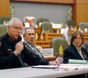 Mike Heal, left, police chief for the city of Aztec, N.M., testifies in support of a state bill that would take away guns temporarily under court orders from people who are considered a danger to themselves or others, in Santa Fe, N.M. Heal says the bill from Democratic state Reps. Daymon Ely, center, and Joy Garratt, right, provides a new tool to keep school students safe.