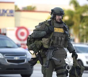 An Orange County Sheriff's Department SWAT member arrives to the scene of a fatal shooting at Pulse Orlando nightclub in Orlando, Fla., Sunday, June 12, 2016.