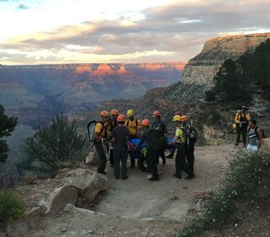 The sunset colors disappearing on the terrain behind our litter team taking a break during a carry out on the Bright Angel Trail. (Photo/Courtesy of the National Park Service)