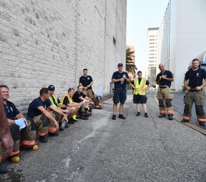 Suppression and Training Division personnel discuss the drill during a debrief.