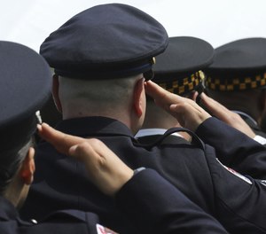 Cook County Sheriff police, along with various police officers, salute during the 21st Annual Peace Officers Ceremony of Recognition and Remembrance on May 10, 2022. A measure to help smaller police departments train and recruit officers has passed the House as of Thursday.