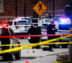 Investigators collect evidence from the pavement as police respond to an attack on campus at Ohio State University.