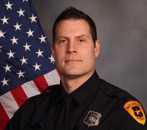 Officer Kevin Peck used a belt as a tourniquet on a crash victim to stop the bleeding.
