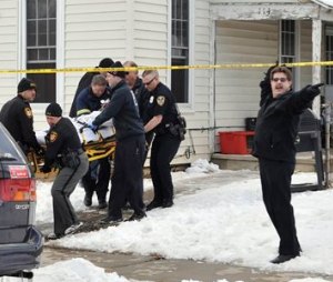 Emergency personnel carry a person out on a stretcher from a home in Troy, Ohio on Friday, Feb. 27, 2015. Two teenage sisters died and two other children were hospitalized after a relative found all four unresponsive from a suspected carbon monoxide leak in the house, officials said. (AP Photo/Piqua Daily Call, Mike Ullery)