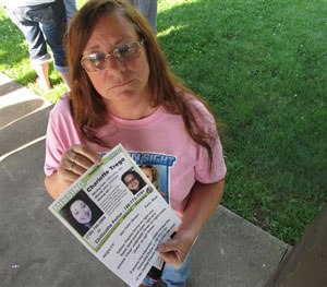 In this June 24, 2015, photo, Yvonne Boggs holds a flier seeking information on her daughter, Charlotte Trego, who has been missing for more than a year, in Chillicothe, Ohio. (AP Image)