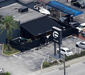 In this June 12, 2016 file photo, law enforcement officials work at the Pulse gay nightclub in Orlando, Fla., following the a mass shooting. (AP Photo/Chris O'Meara, File)