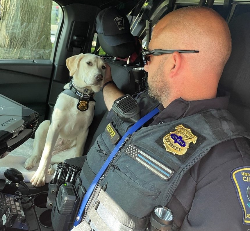 Grace is pictured with her handler Sgt. Kurt Keeper.
