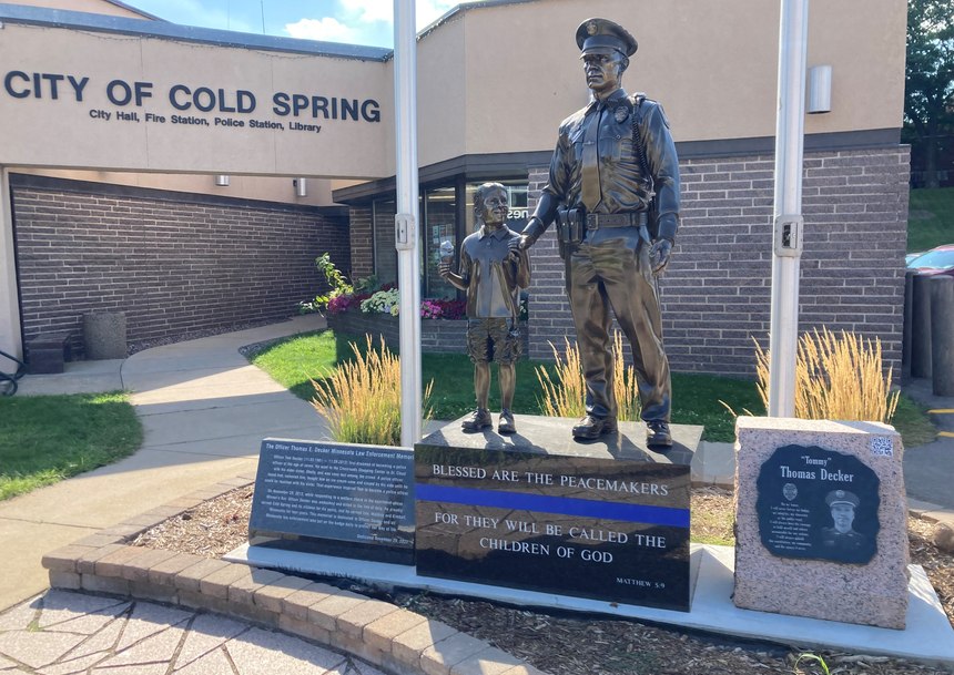 The young boy depicted in the memorial symbolizes Tom Decker as a child.