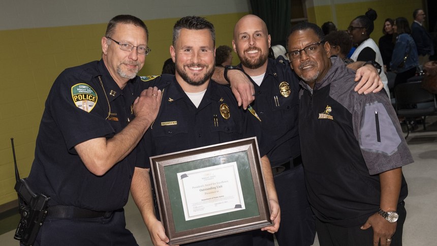 Chief Holden (second from left) and other department leaders after they received the University's 2023 President Award for Excellence for their work in the community.
