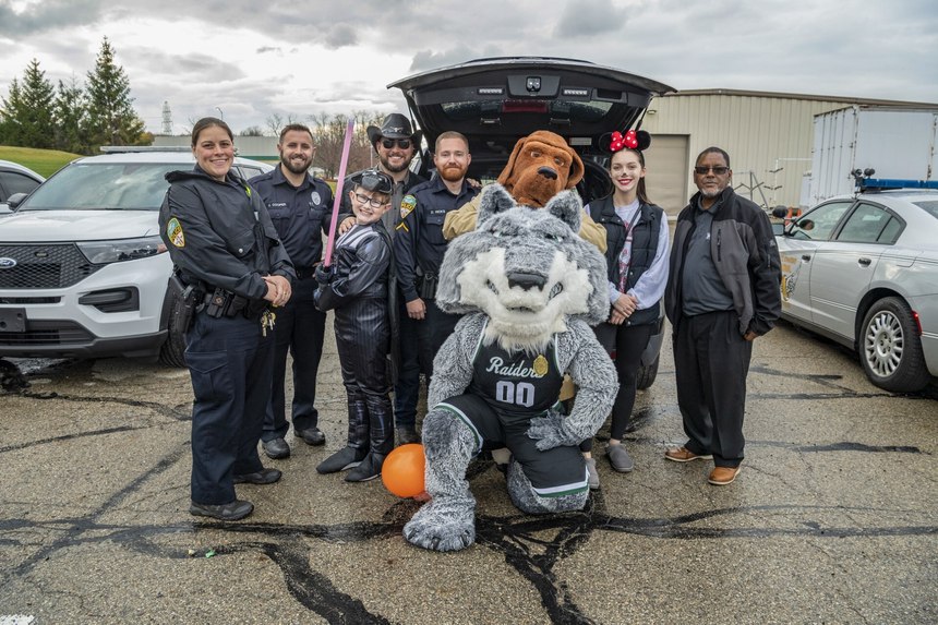 Members of the police department and community at the campus Trunk-or-Treat event.