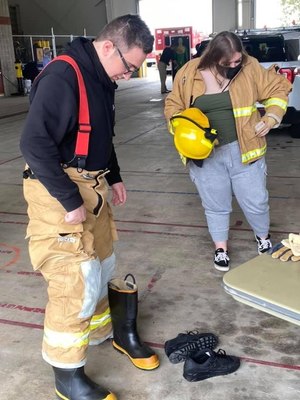 Joseph Miller and Emily Lewandowski don PPE.