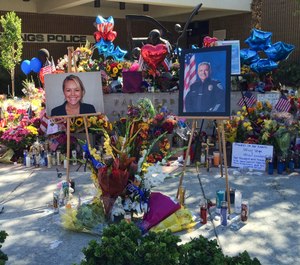 A visitor pays his respects at a memorial for Palm Springs Police Officers Lesley Zerebny, and Jose