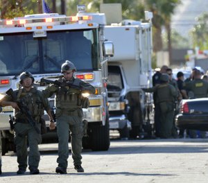 Riverside Country Sheriffs Deputies stand near the scene of a shooting in Palm Springs, Calif., Saturday, Oct. 8, 2016. (AP Photo/Rodrigo Peña)