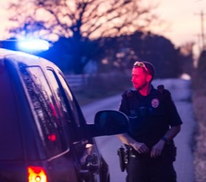 While police were trying to restrain the suspect, he grabbed an officer's firearm and pulled up in an attempt to remove the gun from the holster, according to the criminal complaint.