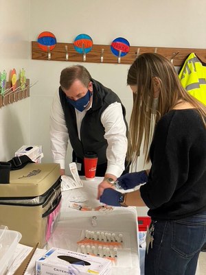 Todd Baker of Advanced Medical Transport and epidemiologist Kate Endress of the Peoria City and County Health Department prepare Moderna COVID-19 vaccine doses for administration. (Photo/Josh Bradshaw)