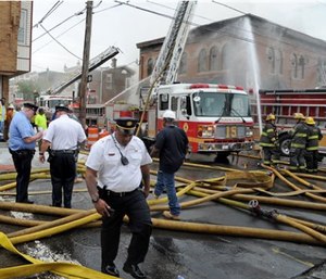 Philadelphia firefighters work to put out a fire at the American Legion Post 396, Monday. (Tom Gralish/The Philadelphia Inquirer via AP)
