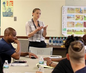 Zoe Maher, a Temple trauma surgeon, explains the Philadelphia Immediate Transport in Penetrating Trauma Trial to community leaders. The study will ask: When gunshot victims are rushed to the emergency room, could paramedics do more to save them by doing less? (AP Photo/ Joseph Kaczmarek)