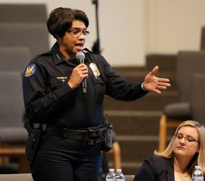 Phoenix Police Chief Jeri Williams speaks at a community meeting, as Phoenix Mayor Kate Gallego, seated, listens, Tuesday, June 18, 2019, in Phoenix. (AP Photo/Ross D. Franklin)