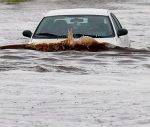 Storms that flooded several Phoenix-area freeways and numerous local streets during the Monday morning commute set an all-time record for rainfall in Phoenix in a single day. (AP Photo/Ross D. Franklin)
