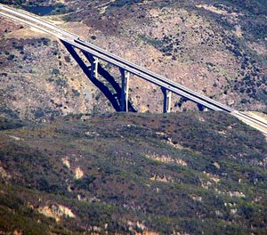 An off-duty firefighter and a Border Patrol agent aided a woman who was threatening to jump off the Pine Valley Creek Bridge on Tuesday, officials say.
