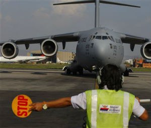 A U.S. Air Force Boeing C-17 Globemaster III lands in Tribhuvan International Airport in Kathmandu, Nepal, Sunday, May 3, 2015. The plane brought in much needed rescue helicopters to fly relief materials and medicine to remote mountainous villages affected by the April 25 earthquake. (AP Photo/Niranjan Shrestha)
