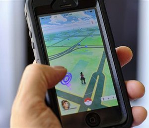 Pokemon Go players have reported wiping out in a variety of ways as they wander the real world. (AP Photo/Richard Vogel)